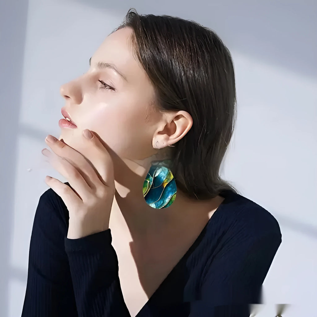 A pair of flat branch knot design drop earrings made from printed acrylic on a white background.