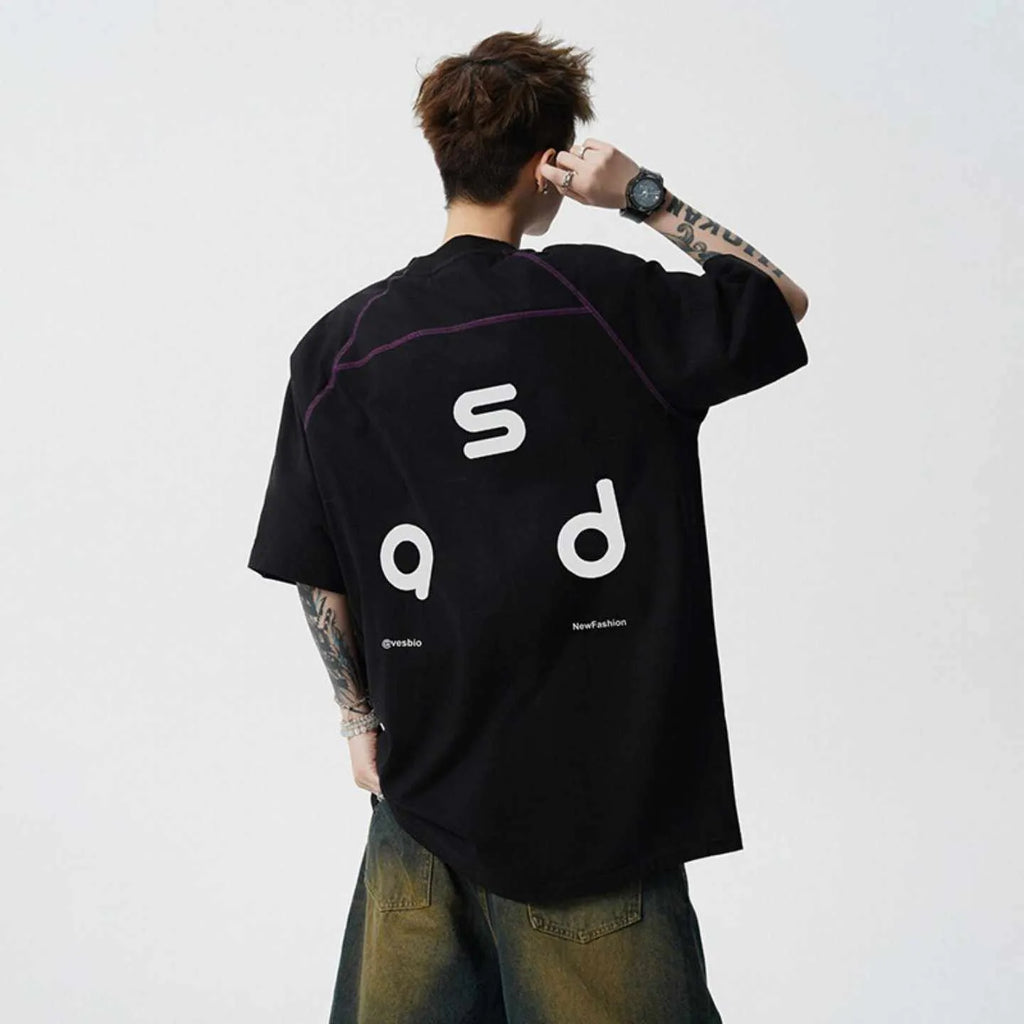 Loose-fit black cotton short-sleeve t-shirt with white letter print graphic on a mannequin.