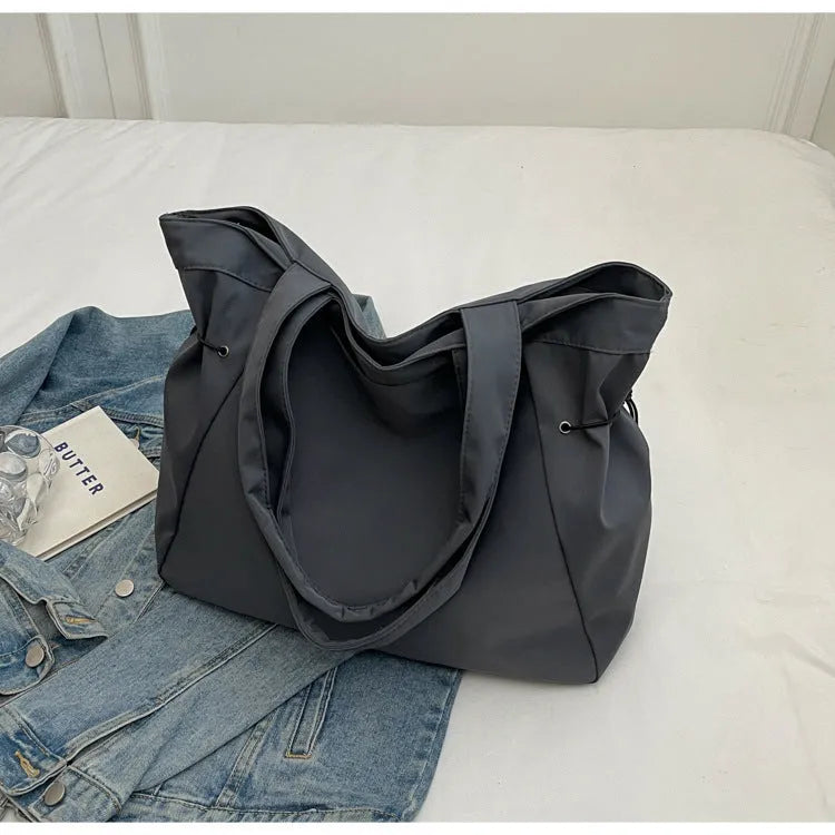 Soft Oxford cloth foldable tote bag in street style, shown in available colours.