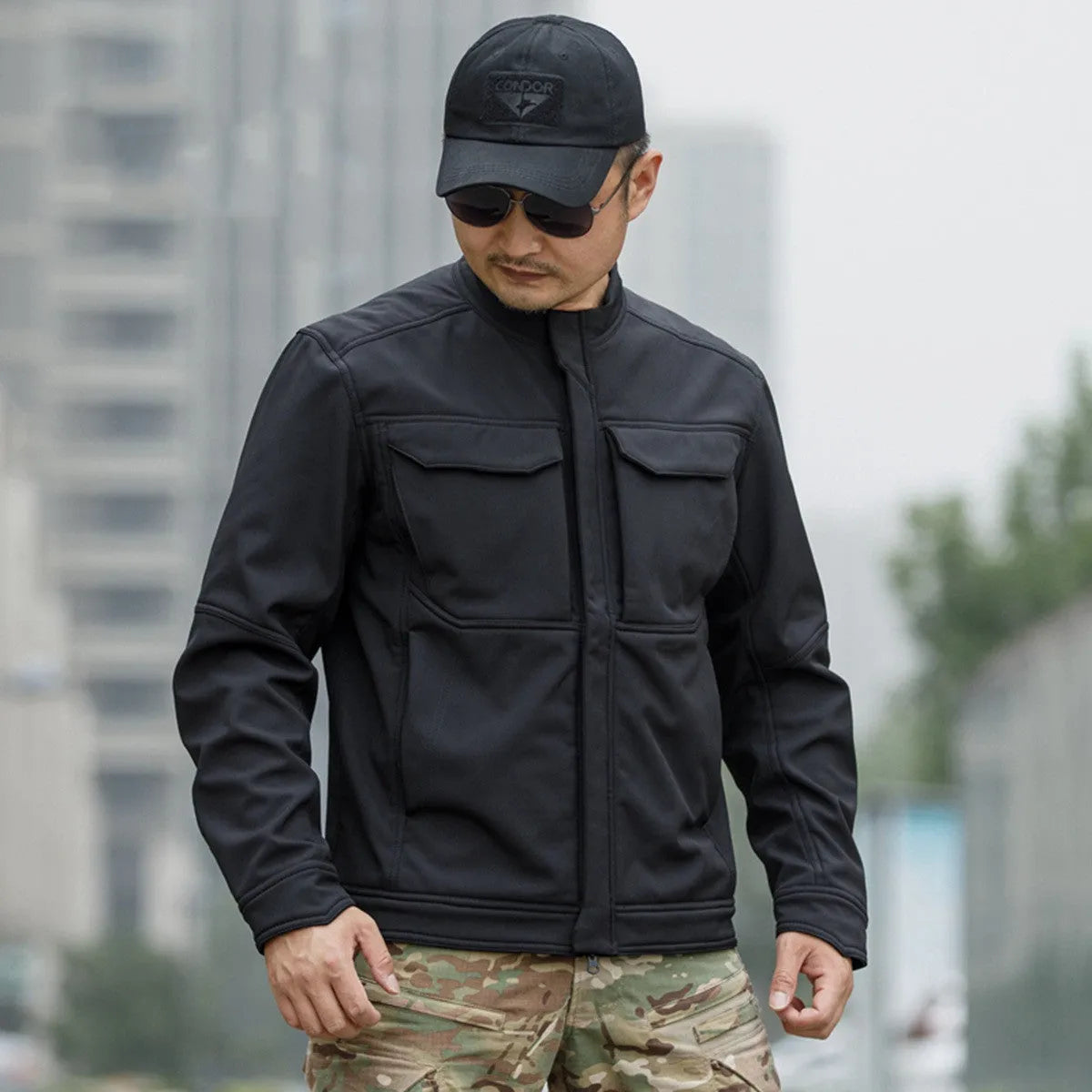 Soft shell tactical jacket for mountaineering and camping in black camouflage colour