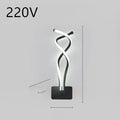 LED wall lamp with silicone shade in black or white finish showing button switch control