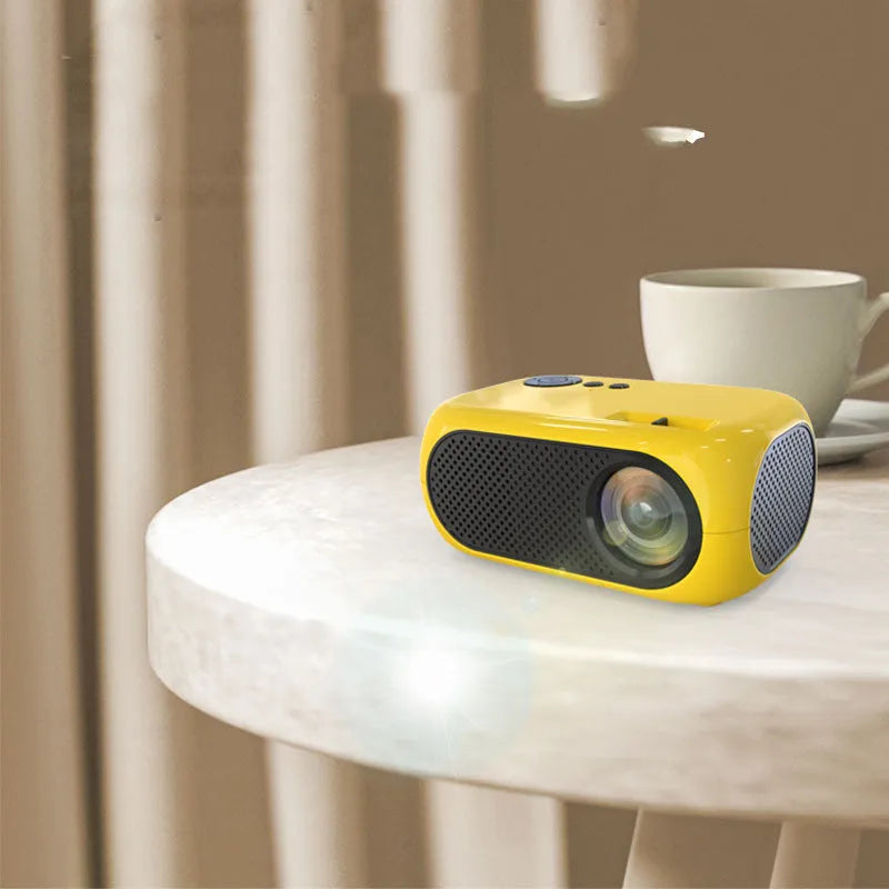 M24 gold micro mini projector with power adapter and AV cable on white background