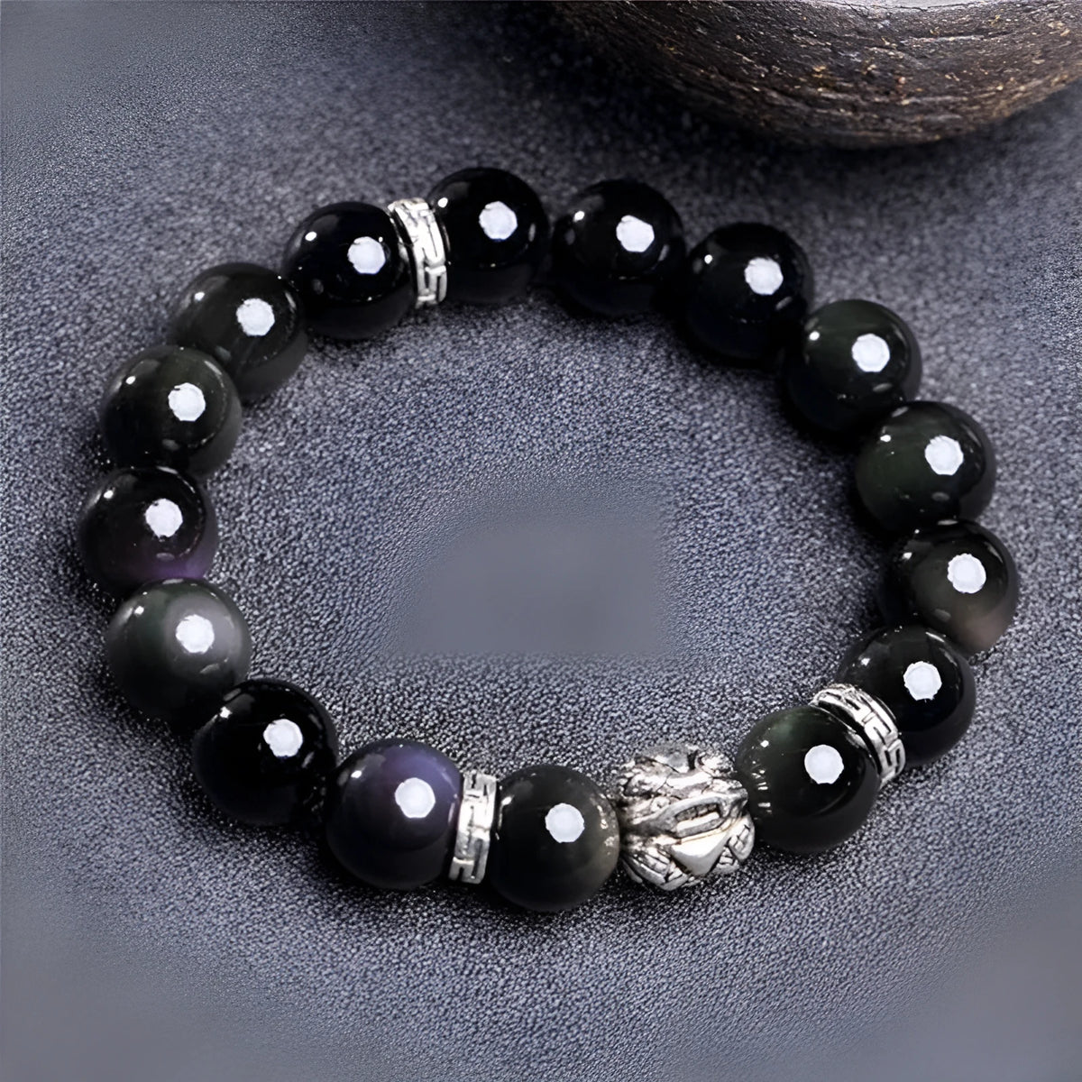 Natural obsidian bracelet with silver 999 clasp in 10mm or 12mm size on a wrist.