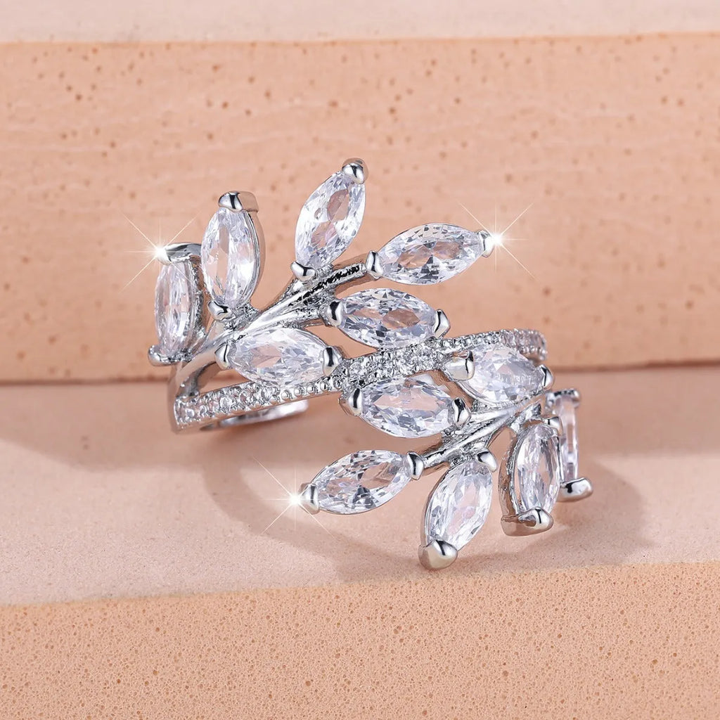 Adjustable copper leaf ring with zircon detailing in multiple colour options on display