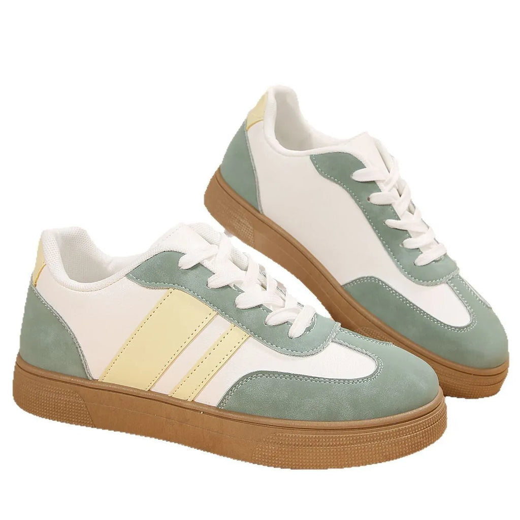 Green women's low-top casual pumps with cross-strap design and flat rubber sole.