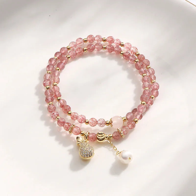Women's geometric strawberry quartz crystal bracelet for money drawing and luck.