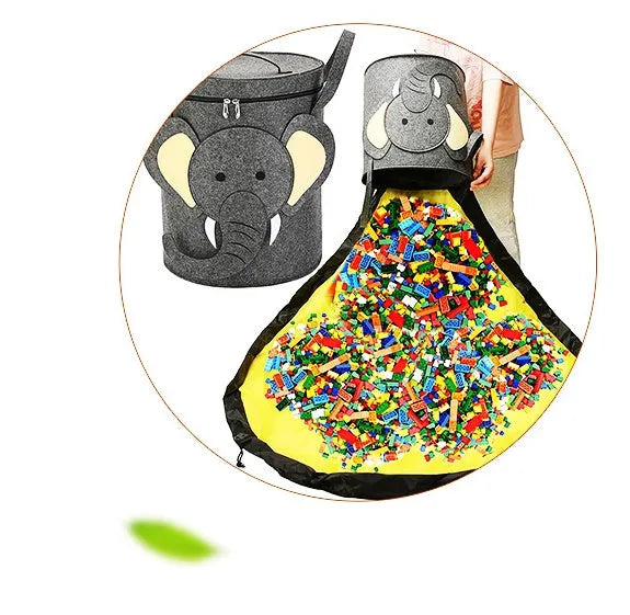 Green cube-shaped felt storage bag with pull rope, laid flat as a play mat.