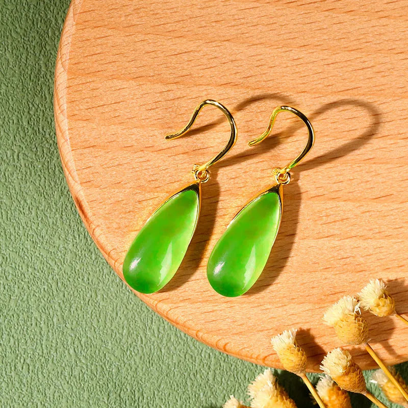 A pair of jade-coloured geometric copper earrings with a water drop element in a Chinese style.