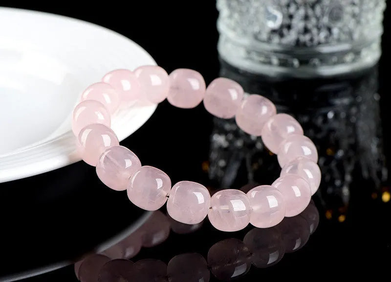 Pink bamboo crystal barrel bead bracelet with geometric design on wrist