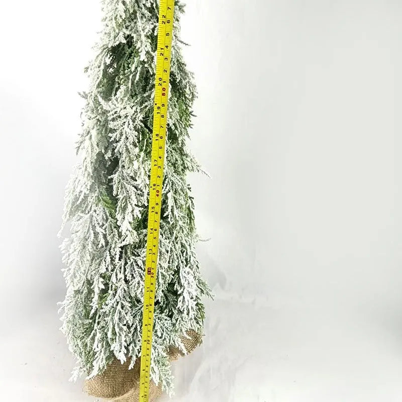 Small 24-inch artificial Christmas tree with LED lights and snow sprayer ornament on desktop