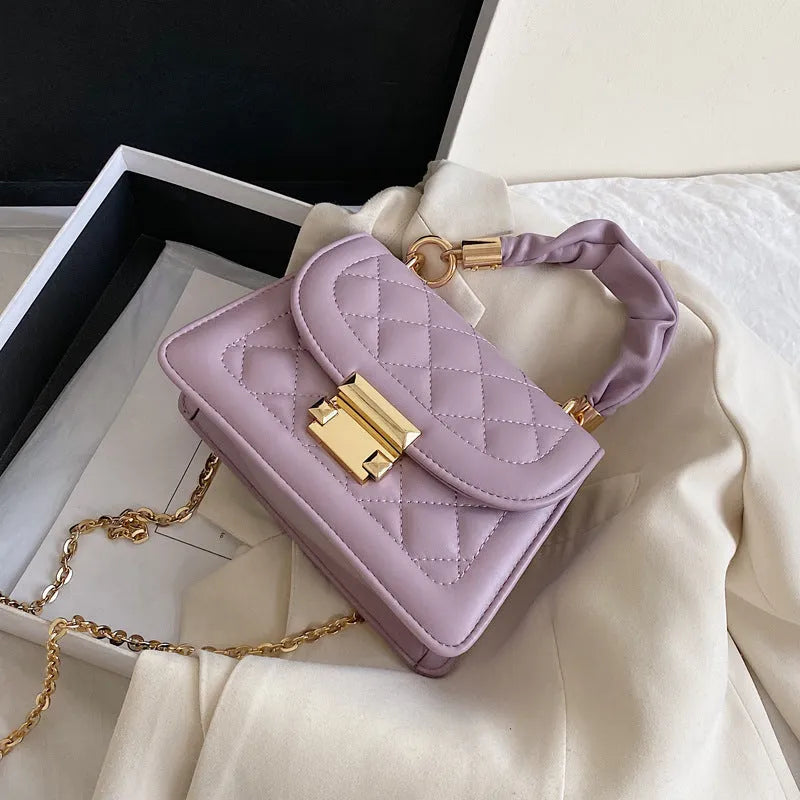 Women's purple PU fabric small square shoulder bag with 112cm strap showing rhombus shape and compact dimensions