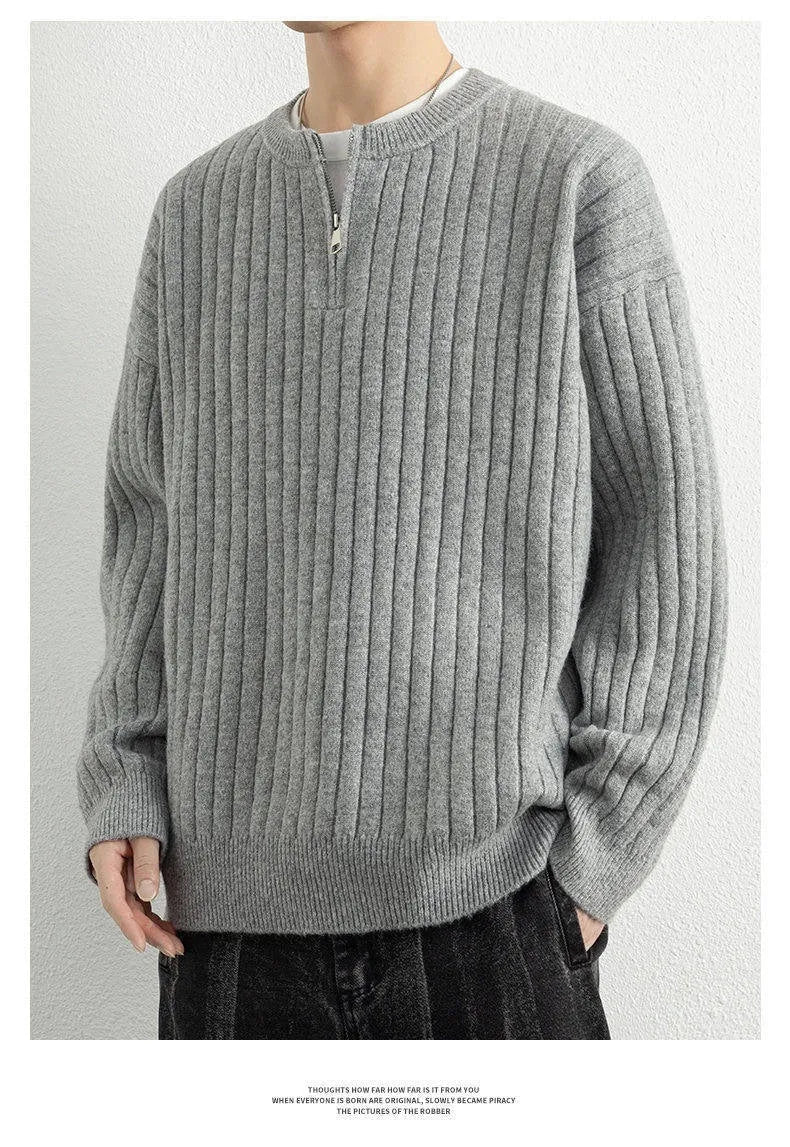 Men's grey half zip textured knit sweater with a loose fit and long sleeves.