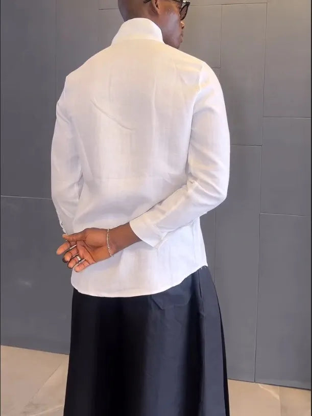 White asymmetric long sleeve shirt paired with black pleated pants in casual two-piece set