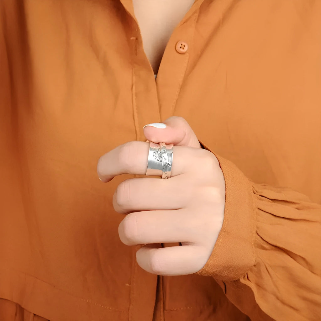 Silver rotatable flower ring showing spinning petals on alloy band
