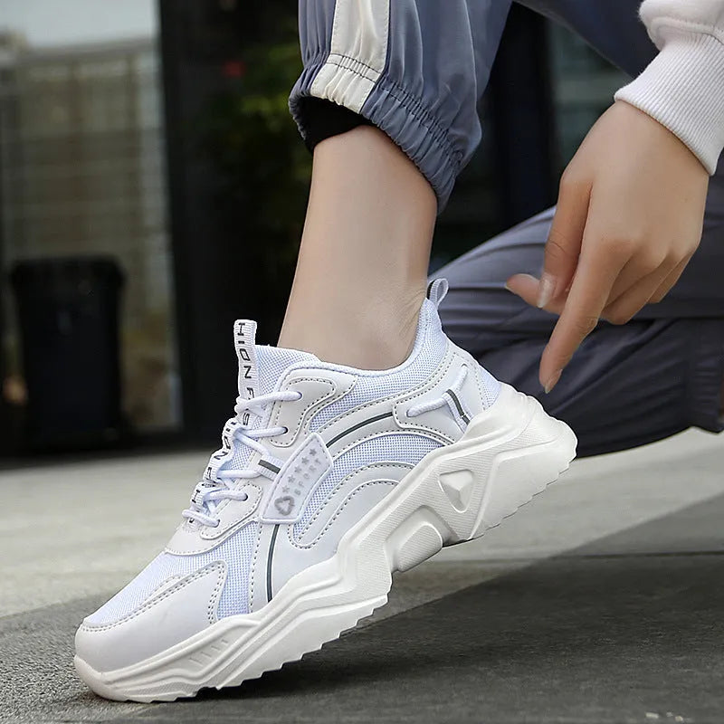 White women's casual sports shoes with mesh upper, thick PU sole, round toe, and buckle detail.