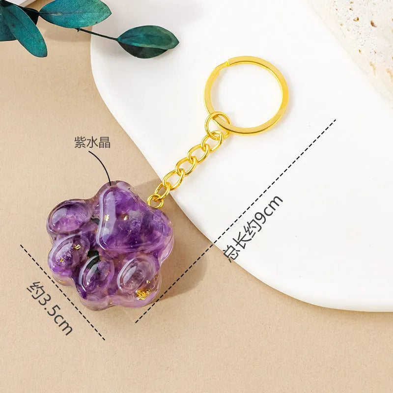 Small handcrafted crystal cat's paw shaped keychain pendant on a keyring.