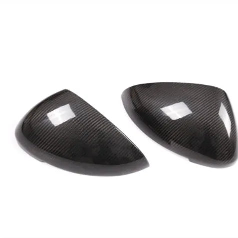 Pair of true carbon fibre rearview mirror covers for Porsche Macan, showing black woven texture.