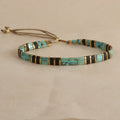 Geometric glass beaded bracelet in milky white, black, green, blue, or red on a white background.