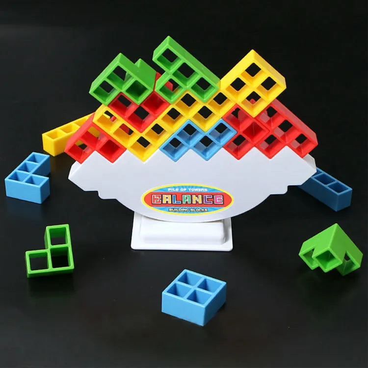 Plastic balance stacking board game with 16 coloured blocks, chassis, and base on a table