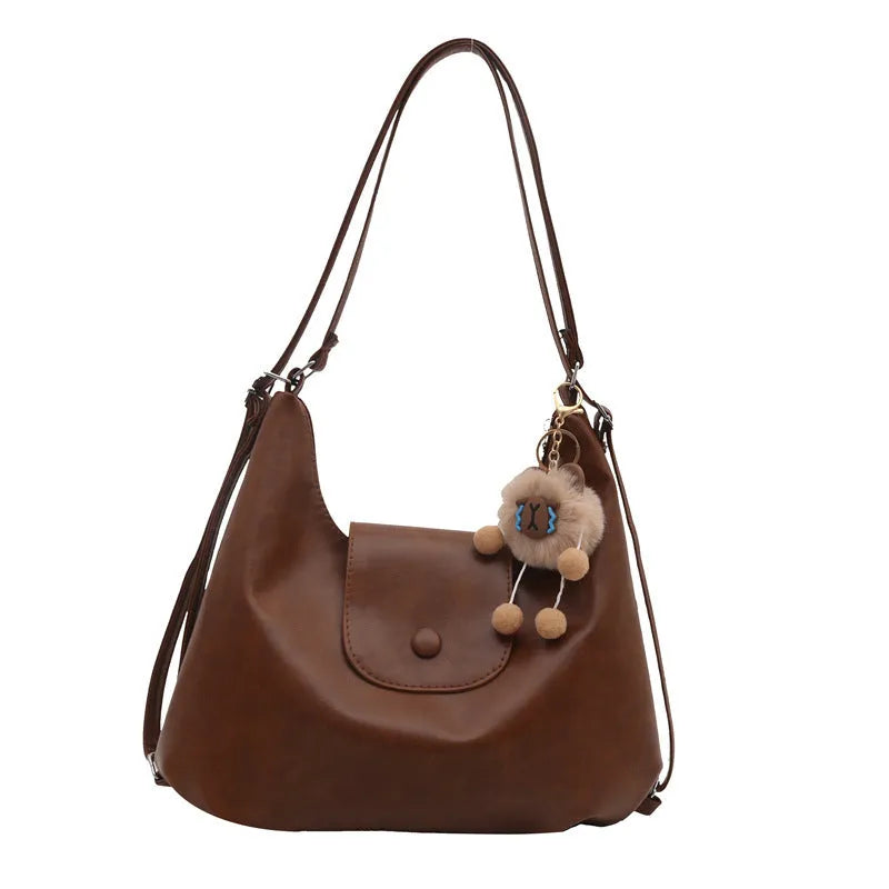 Black leather PU women's single-shoulder backpack with textured finish and horizontal square shape