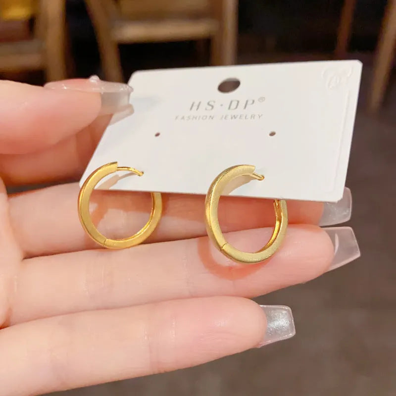 Geometric circular gold plated ear clip for women with eyelet clip mechanism