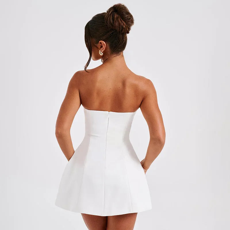 Black backless tube dress with slim fit and short A-line skirt on a model.