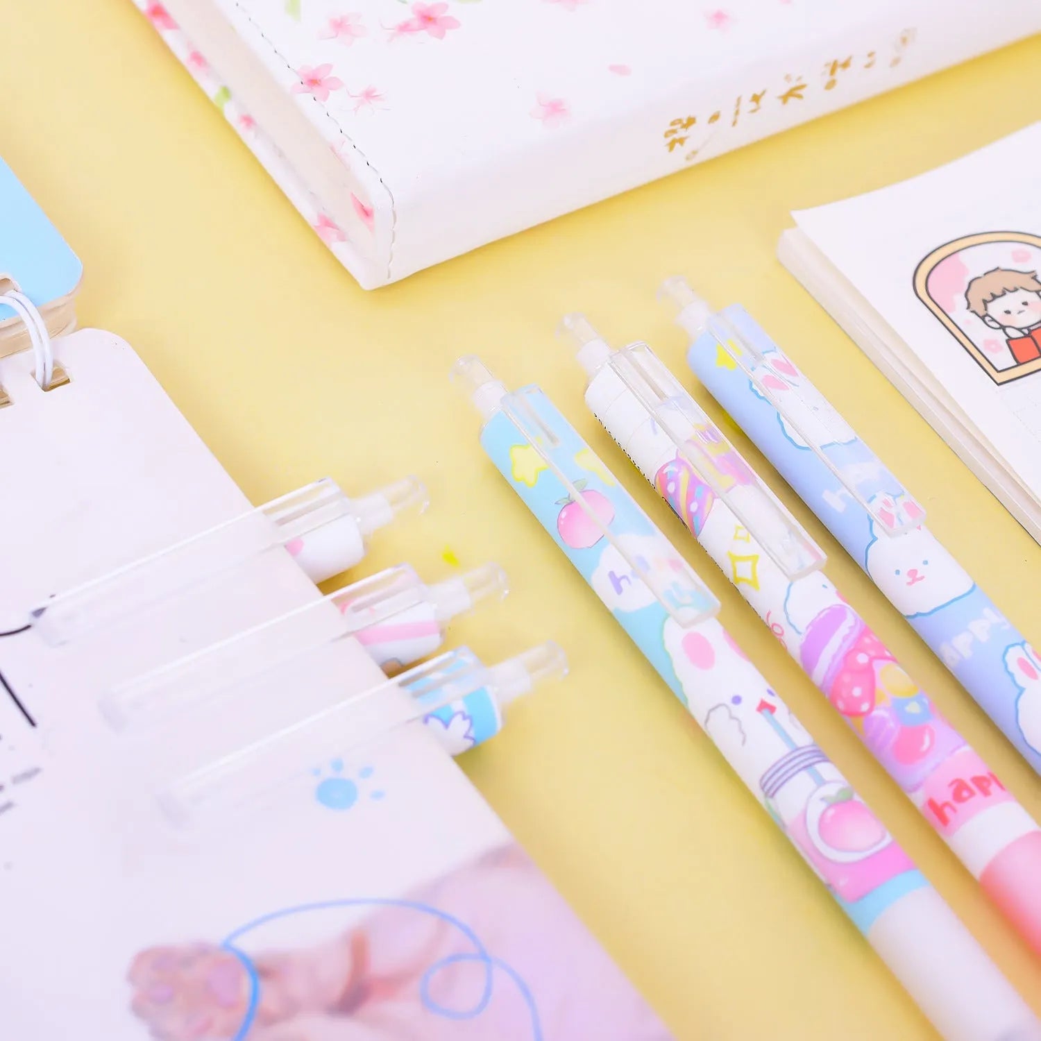 Six black plastic pens with cartoon bunny designs and 0.5mm tips arranged in stationery set