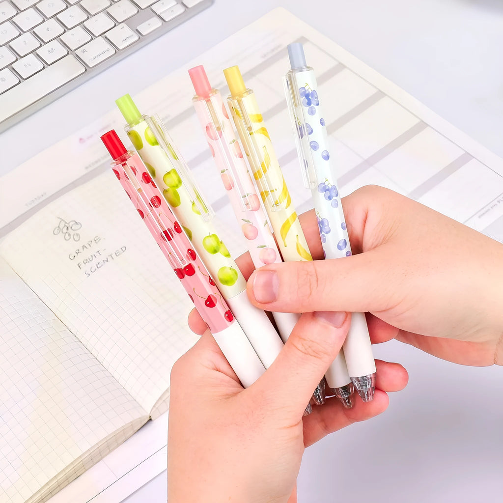 Three fruit-scented press-action pens with plastic barrels and black 0.5mm refills.