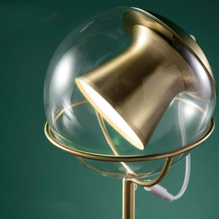 Clear glass desk lamp with touch dimmer and LED light on a wooden table