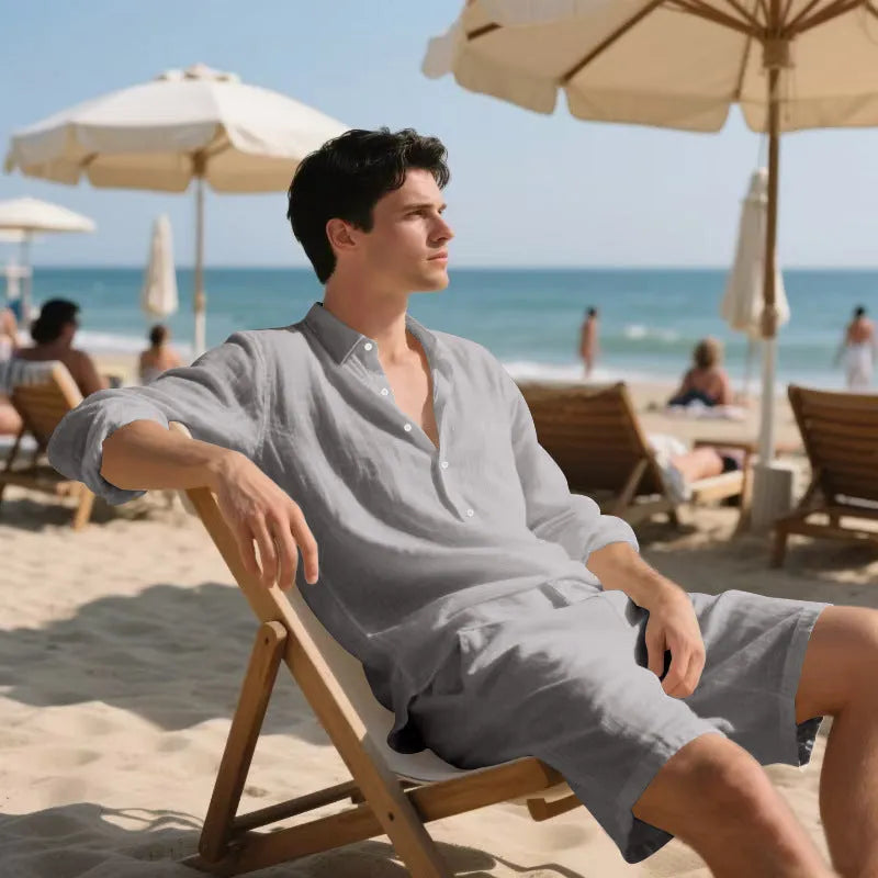 A man wearing a light blue linen long sleeve shirt and matching shorts from the beach suit set.