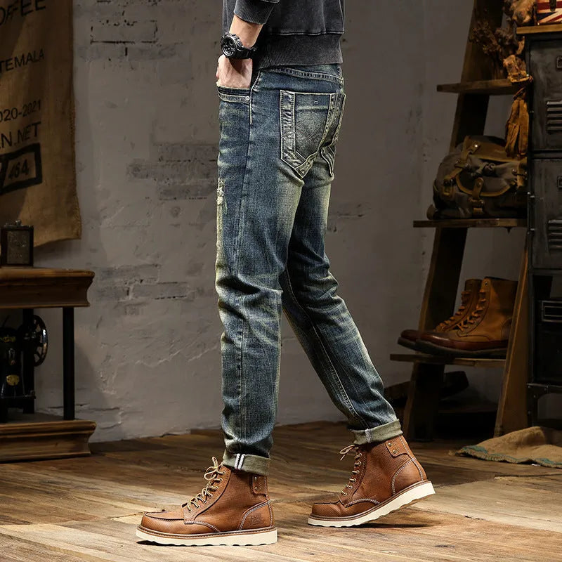 Men's skinny fit jeans in retro blue denim with a zip fly, shown laid flat.
