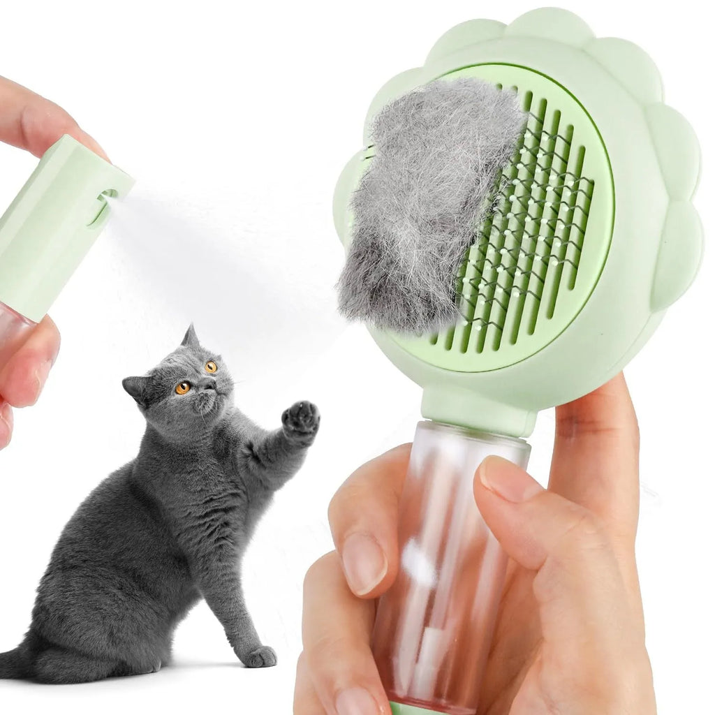 Grey spray grooming brush for cats with a self-cleaning button and curved stainless steel bristles.