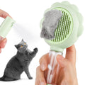 Grey spray grooming brush for cats with a self-cleaning button and curved stainless steel bristles.