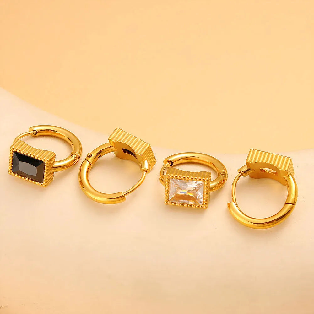Square geometric stainless steel earrings with round ring details in white, black, or green electroplated finish.