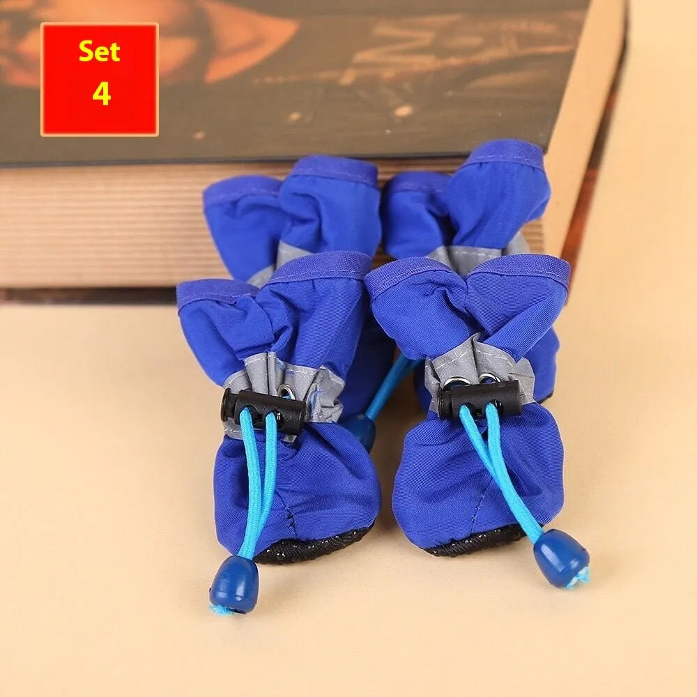 Set of four cloth dog shoes in various colours including fleece-lined red and monkey patterns
