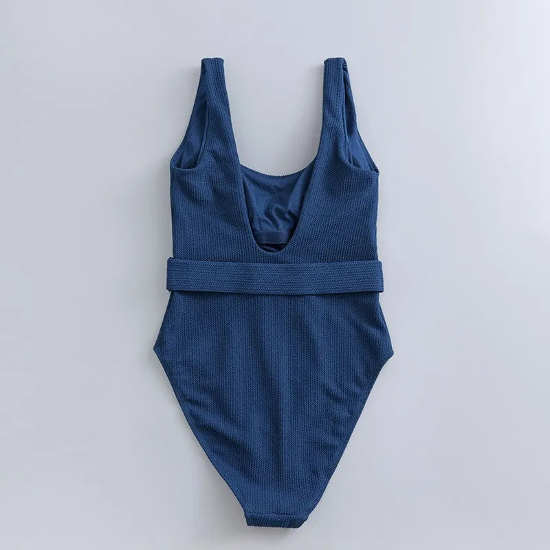 Navy blue women's one-piece swimsuit with triangle design and chest pads