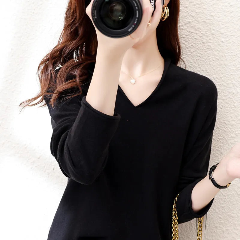 Women's turmeric V-neck long sleeve knitwear top laid flat.