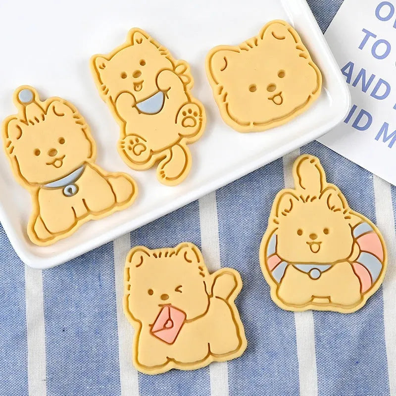 Three dimensional press plastic biscuit mould showing cartoon puppy designs