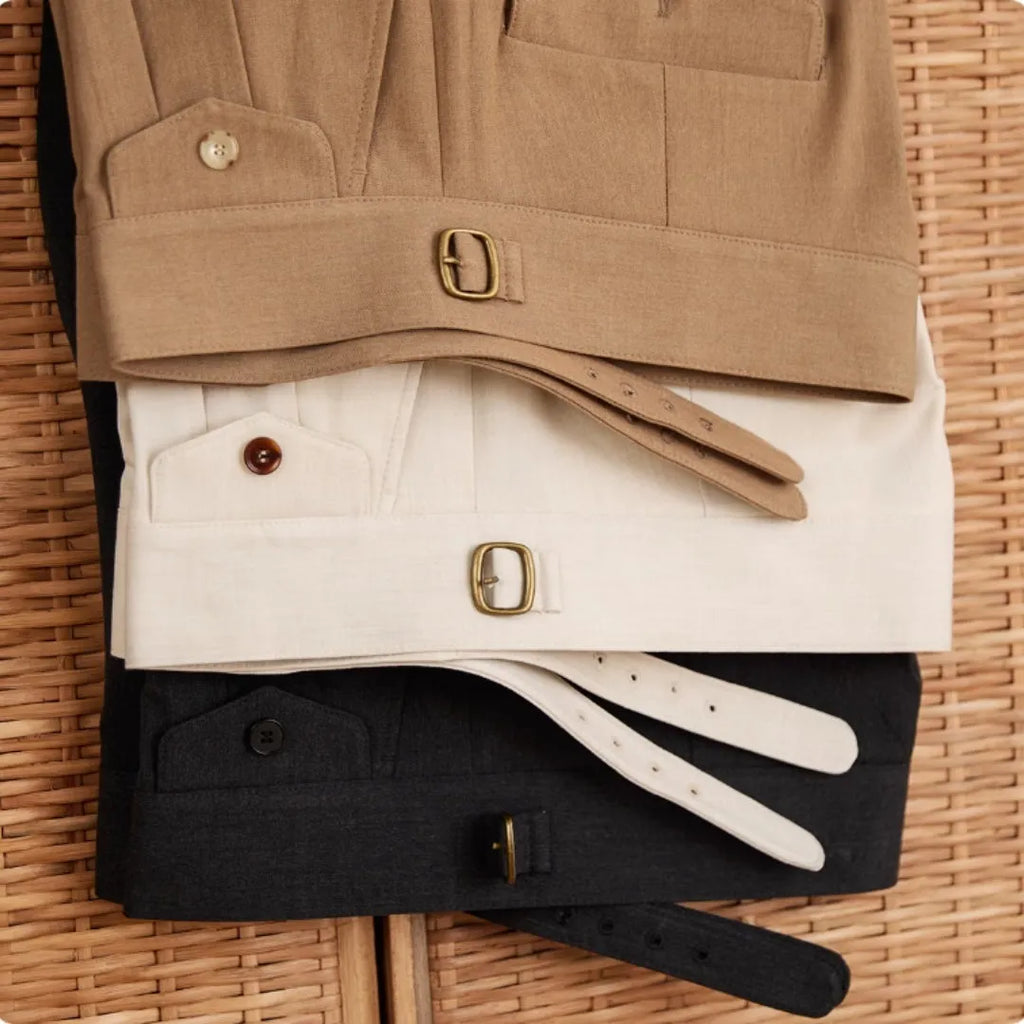 Men's slim fit straight leg trousers in wrinkle-resistant polyester fabric on a hanger.