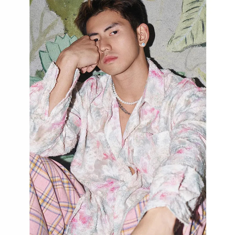 Women's pink floral long sleeve shirt with embossed pattern and loose fit on hanger