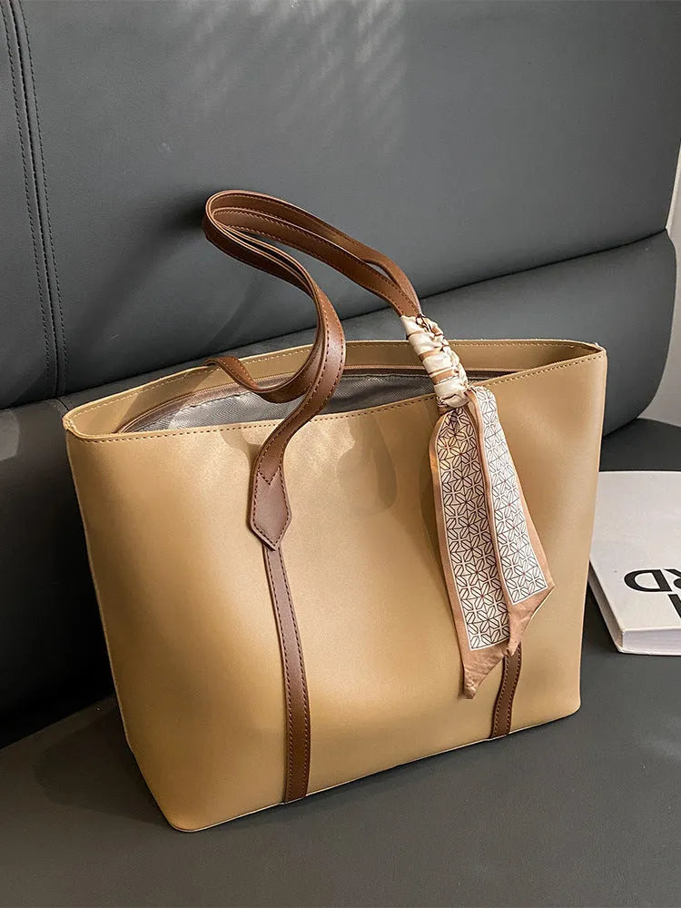 Women's casual tote bag with bucket design showing shoulder strap and crossbody carrying option