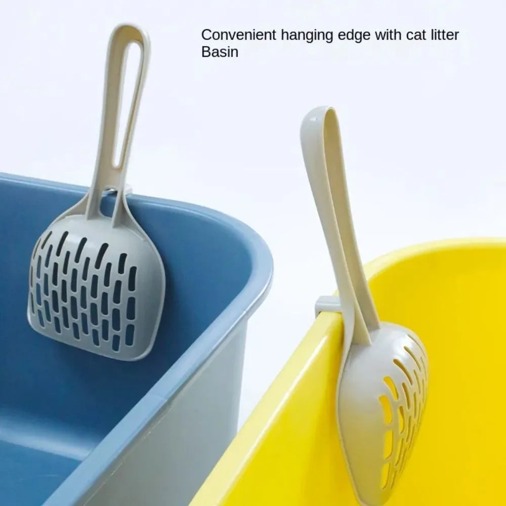 Gray plastic cat litter scoop with matching upright base for self-cleaning kitten toilet maintenance