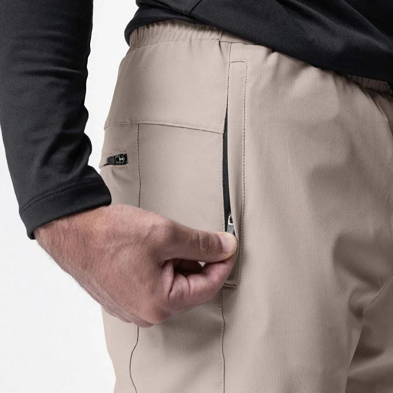 Man wearing loose grey ankle-tie fitness trousers suitable for running and gym workouts.