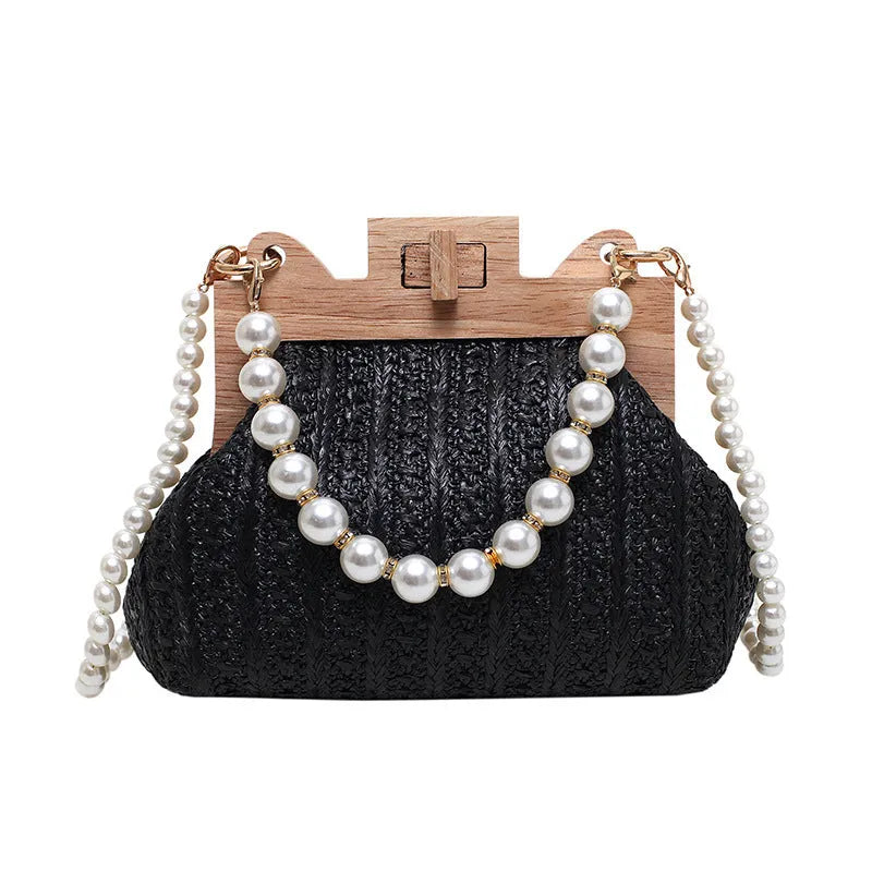 Women's straw woven shoulder bag with pearl chain trim showing internal compartments