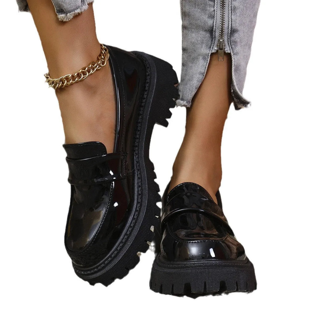 Plus size women's black slip-on loafers with a chunky mid-heel platform and rubber sole