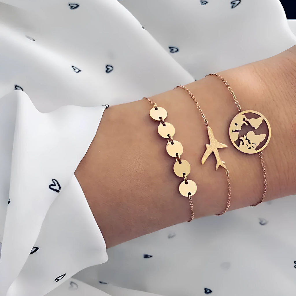 Three Bohemian-style bracelets with heart-shaped alloy charms featuring aircraft map designs