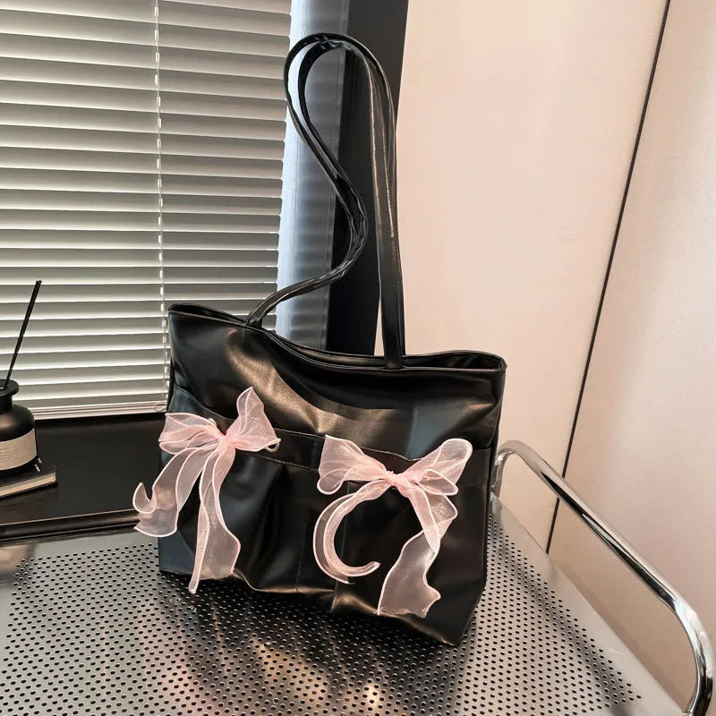 College style bow tote bag in black or pink with double shoulder straps and zippered compartment