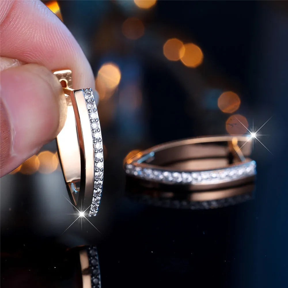 Geometric V-shaped champagne gold women's ear clips with white diamond accents.