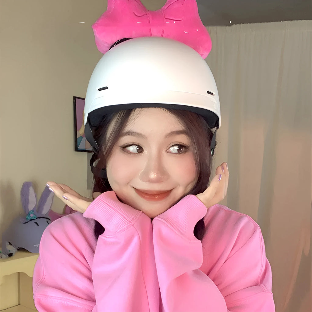 Soft plush bow helmet decoration with pom-pom in red, pink, and peach colour options.