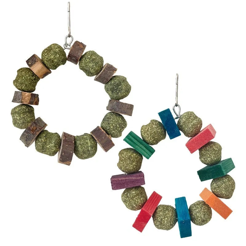 Small pet chew toy showing a ring with a decorative straw ball, in either sequin or applewood style.